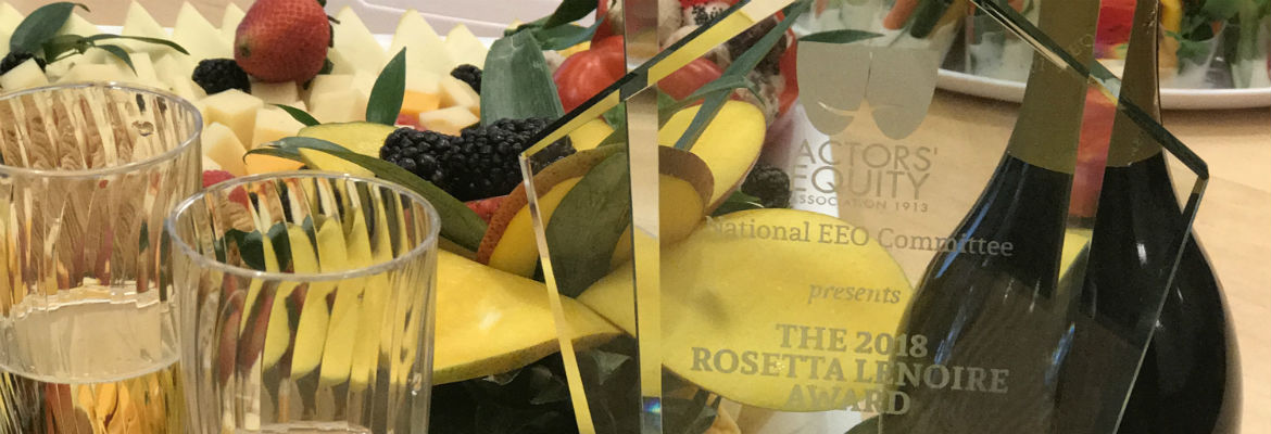 The LeNoire Award plaque sits on a table surrounded by fruit, cheese and champagne