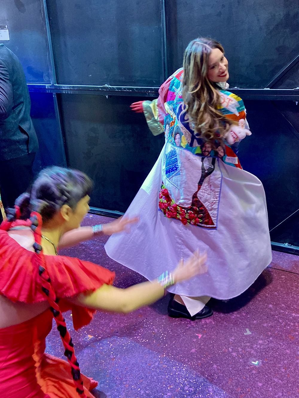 While Ramirez poses in the Robe, Aline Mayagoitia kowtows to her.