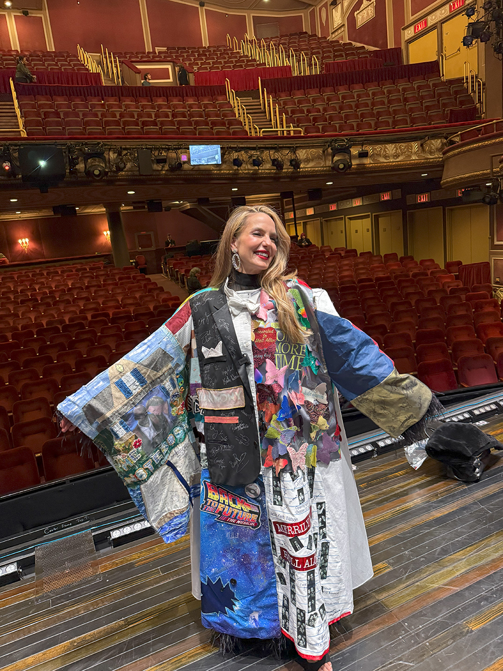 Katie Webber poses in the Robe onstage, the house visible behind her.
