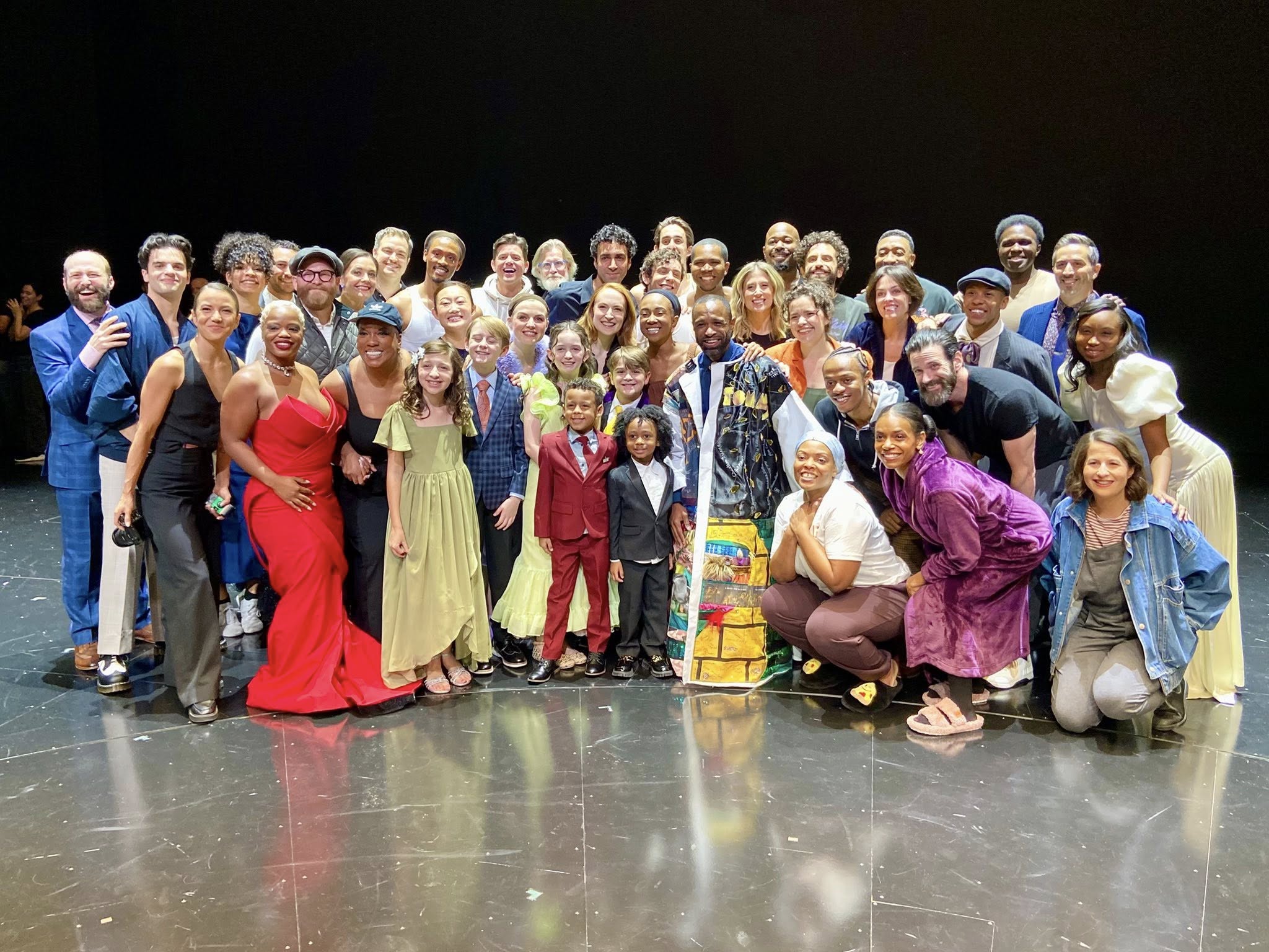 Alan Wiggins poses onstage in the Robe, surrounded by over 40 castmates.