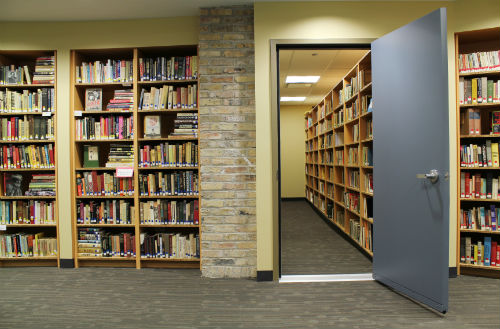 rows of full bookcases at the library